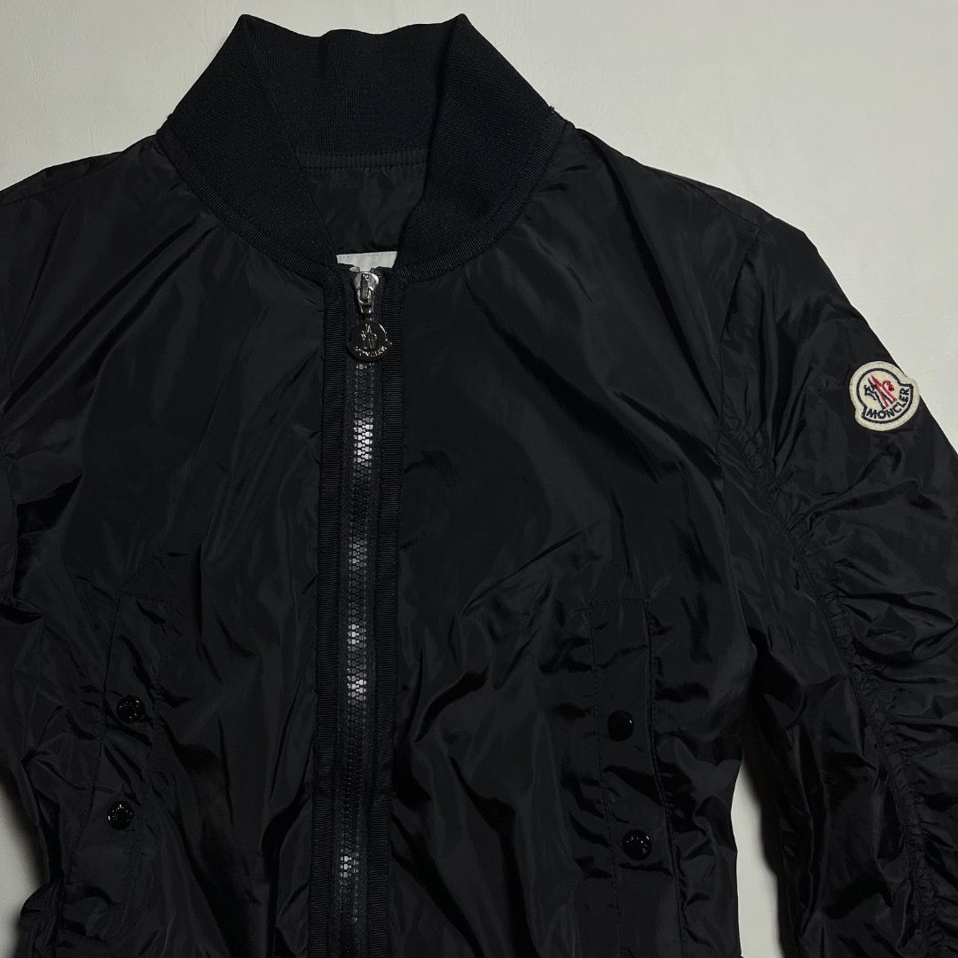 Moncler Black Bomber Jacket Ruffled Hem (Category: Coats, Jackets and Outerwear) located in Caloocan City. Submitted by achilles_grails (Listing ID 1471046678, Image 2). Description: - Authentic Moncler black nylon bomber jacket - Full zip front closure with branded metallic hardware - Classic ribbed collar and cuffs with trendy ruched sleeves - Practical button-flap front pockets - Unique ruffled knit hem with adjustable drawstrings for a custom