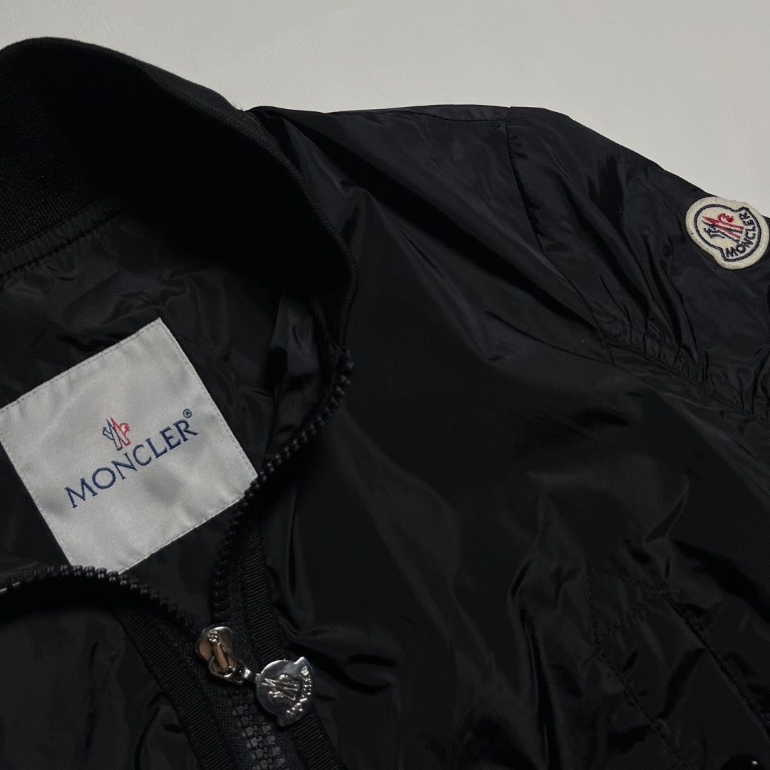 Moncler Black Bomber Jacket Ruffled Hem (Category: Coats, Jackets and Outerwear) located in Caloocan City. Submitted by achilles_grails (Listing ID 1471046678, Image 3). Description: - Authentic Moncler black nylon bomber jacket - Full zip front closure with branded metallic hardware - Classic ribbed collar and cuffs with trendy ruched sleeves - Practical button-flap front pockets - Unique ruffled knit hem with adjustable drawstrings for a custom