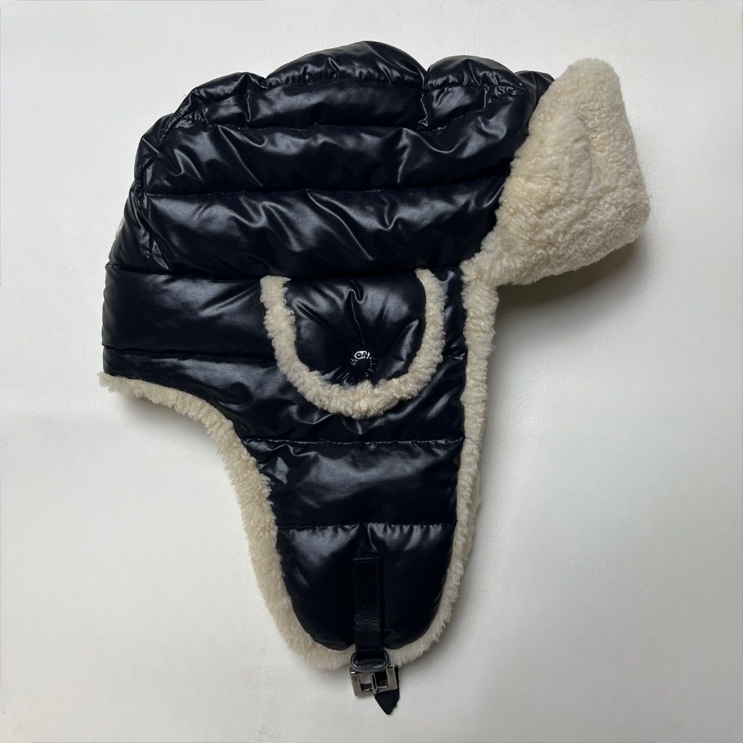 Moncler Down Filled Shearling Trapper Hat Size L (Category: Caps & Hats) located in Caloocan City. Submitted by achilles_grails (Listing ID 1471078686, Image 3). Description: - Authentic Moncler trapper hat in black - Down-filled quilted nylon with thick cream shearling lining and ear flaps - Adjustable chin strap with secure metal buckle closure - Size: L - Origin: Made in Italy - Condition: Excellent, ready to wear.