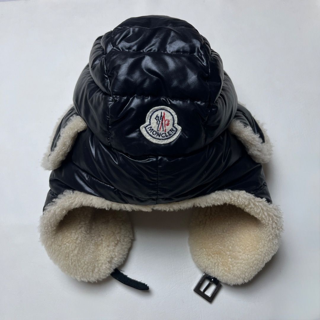 Moncler Down Filled Shearling Trapper Hat Size L (Category: Caps & Hats) located in Caloocan City. Submitted by achilles_grails (Listing ID 1471078686, Image 1). Description: - Authentic Moncler trapper hat in black - Down-filled quilted nylon with thick cream shearling lining and ear flaps - Adjustable chin strap with secure metal buckle closure - Size: L - Origin: Made in Italy - Condition: Excellent, ready to wear.