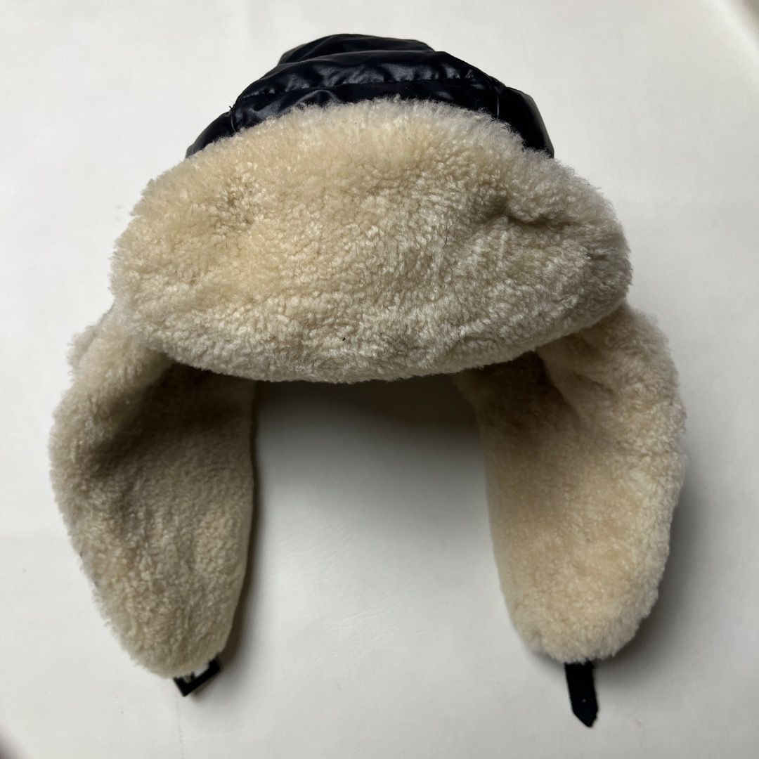 Moncler Down Filled Shearling Trapper Hat Size L (Category: Caps & Hats) located in Caloocan City. Submitted by achilles_grails (Listing ID 1471078686, Image 2). Description: - Authentic Moncler trapper hat in black - Down-filled quilted nylon with thick cream shearling lining and ear flaps - Adjustable chin strap with secure metal buckle closure - Size: L - Origin: Made in Italy - Condition: Excellent, ready to wear.