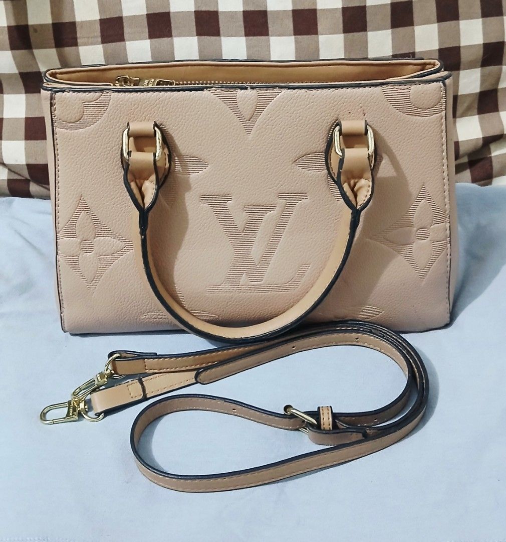 Monogram Tote Hand/Sling Bag (Beige) (Category: Cross-body Bags) located in Las Pinas. Submitted by anna_katrina (Listing ID 1471035833, Image 1). Description: -Material: Embossed leather in a versatile beige shade - Design: Structured shape with dual top handles - Closure & Storage: Secure zip compartment inside - Strap: Includes a long detachable shoulder strap with gold-tone hardware - Interior: Chic striped fabric lining complete with a signa