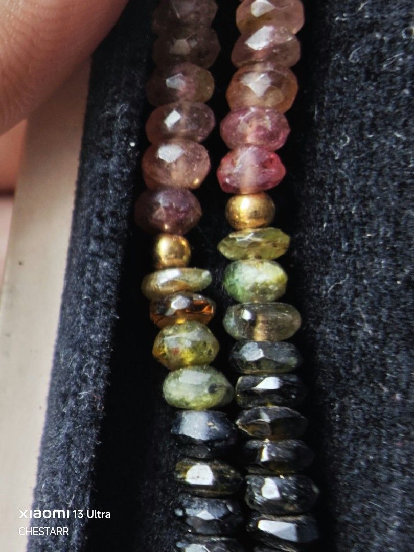 Multicolor Tourmaline Beaded Necklace with Box (Category: Necklaces) located in Cauayan City . Submitted by chestarrprelovedauthentic (Listing ID 1470969353, Image 3). Description: - Beautiful multicolor tourmaline faceted beads with a stunning color gradient from black to vibrant pinks, oranges, and greens - Enhanced with elegant gold-toned metal beads and small spacers - Features a secure clasp with a small Japanese hallmark stamp - Standard ne