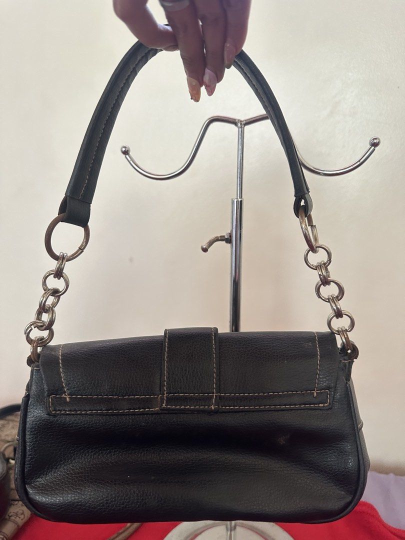 Natasha Black Leather Shoulder Bag with Chain Strap (Category: Shoulder Bags) located in Manila. Submitted by goldenhorse-dafc (Listing ID 1470985764, Image 3). Description: Black textured leather shoulder bag from Natasha. Front flap closure with buckle detailing and metal grommets. Dual side pockets with zipper closures. Silver-tone chain links on the strap. Fabric lined interior with inner zip pocket and brand label inside..