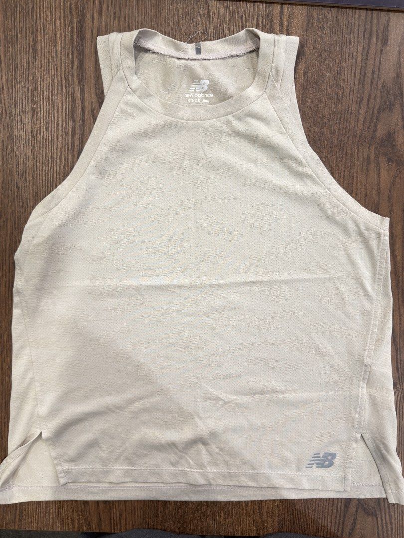 New Balance Running Tank Top Size S (Category: Activewear) located in Angeles City. Submitted by beyond.this (Listing ID 1470985770, Image 1). Description: - Brand: New Balance - Color: Beige - Size: S (US/EU S, JP M, AU 5/10) - Origin: Made in Indonesia - Material: Lightweight, breathable athletic fabric - Design: Scoop neckline, sleeveless, side slits at the hem, and small logo near the bottom corner - Condition: Brand new with tags.