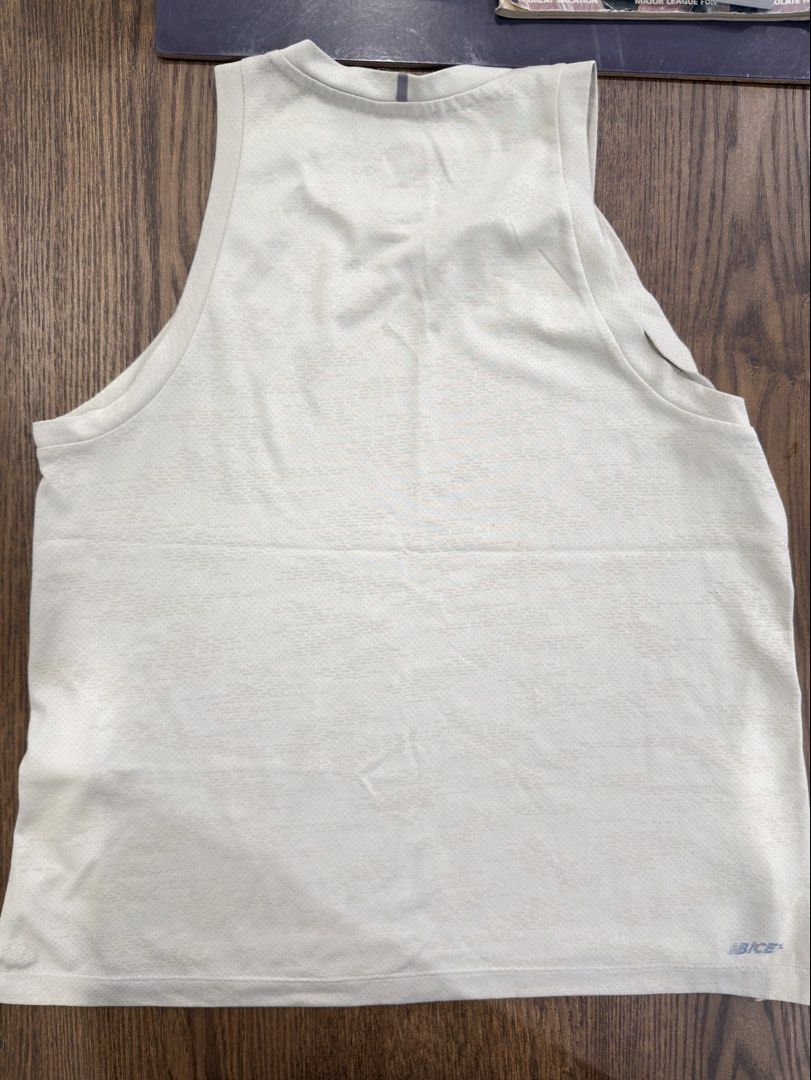 New Balance Running Tank Top Size S (Category: Activewear) located in Angeles City. Submitted by beyond.this (Listing ID 1470985770, Image 3). Description: - Brand: New Balance - Color: Beige - Size: S (US/EU S, JP M, AU 5/10) - Origin: Made in Indonesia - Material: Lightweight, breathable athletic fabric - Design: Scoop neckline, sleeveless, side slits at the hem, and small logo near the bottom corner - Condition: Brand new with tags.