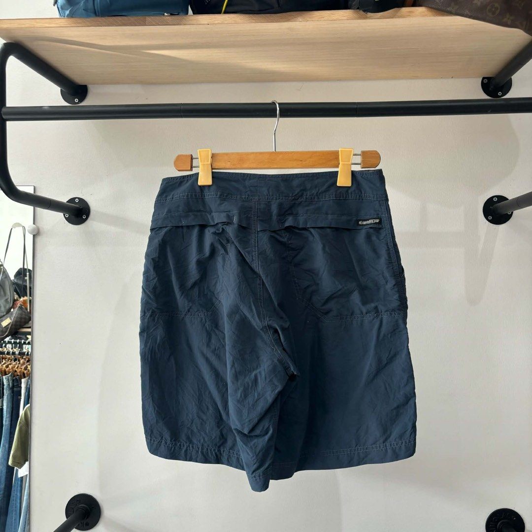 Nike ACG Navy Nylon Cargo Shorts Size 32 (Category: Shorts) located in Bambang. Submitted by heats777 (Listing ID 1471010957, Image 2). Description: - Brand/Line: Nike ACG - Item: Nylon cargo shorts - Color: Dark navy blue - Size: 32 (Medium) - Material: 100% polyamide (lightweight & quick-drying) - Features: Multiple functional pockets on front and back - Origin: Made in Indonesia - Condition: Clean, excellent overall condition.