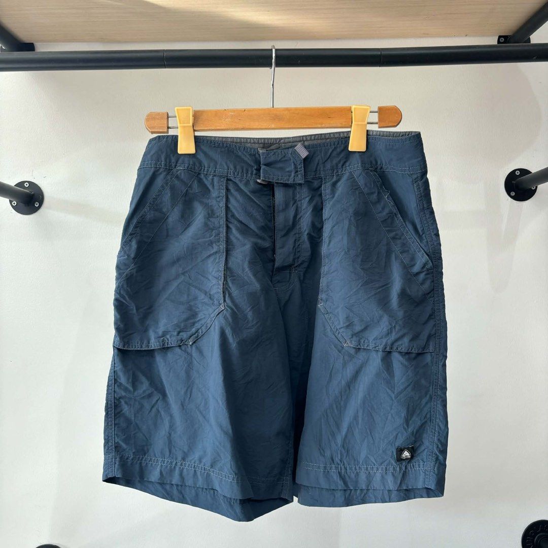 Nike ACG Navy Nylon Cargo Shorts Size 32 (Category: Shorts) located in Bambang. Submitted by heats777 (Listing ID 1471010957, Image 1). Description: - Brand/Line: Nike ACG - Item: Nylon cargo shorts - Color: Dark navy blue - Size: 32 (Medium) - Material: 100% polyamide (lightweight & quick-drying) - Features: Multiple functional pockets on front and back - Origin: Made in Indonesia - Condition: Clean, excellent overall condition.