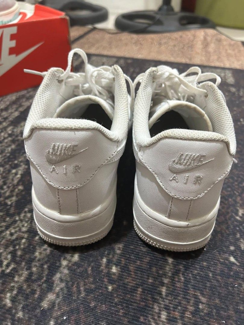 Nike Air Force 1 Low Triple White (Category: Sneakers) located in Manila. Submitted by andrew1517 (Listing ID 1471042487, Image 2). Description: - Brand: Nike - Style: Classic All-White Low Top Sneakers - Features: Crisp leather upper, perforated toe box, chunky rubber sole with Air cushioning, and silver AF1 lace dubraes - Inclusions: Original box included - Condition: Pre-owned with minor crease lines on the toe box and normal signs of wear on 