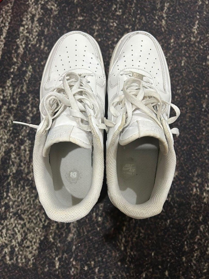 Nike Air Force 1 Low Triple White (Category: Sneakers) located in Manila. Submitted by andrew1517 (Listing ID 1471042487, Image 3). Description: - Brand: Nike - Style: Classic All-White Low Top Sneakers - Features: Crisp leather upper, perforated toe box, chunky rubber sole with Air cushioning, and silver AF1 lace dubraes - Inclusions: Original box included - Condition: Pre-owned with minor crease lines on the toe box and normal signs of wear on 
