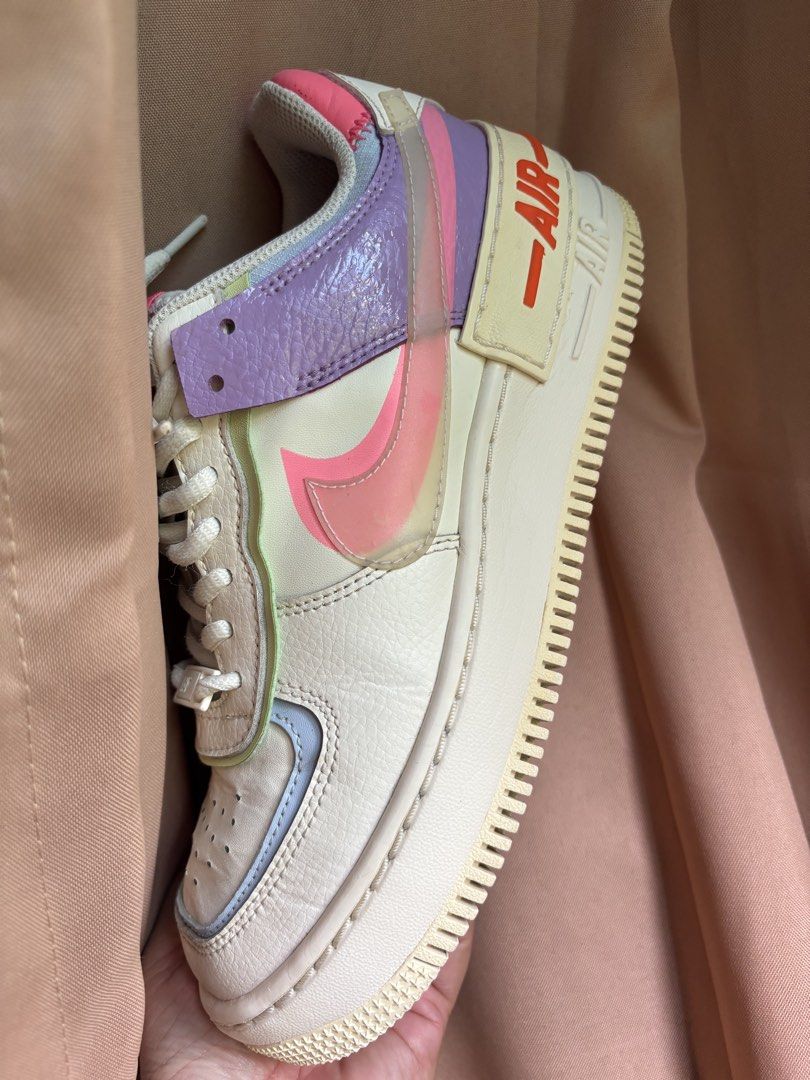 Nike Air Force 1 Shadow Pastel Sneakers (Category: Sneakers) located in Bacacay. Submitted by true.carmiebalq (Listing ID 1471115529, Image 1). Description: - Model: Nike Air Force 1 Shadow - Colorway: Pastel multi-color (lavender, pink, pale blue, and off-white) - Design: Layered panels, double branding elements, and translucent pink swoosh overlay - Sole: Chunky layered midsole with red AIR lettering at the heel - Details: Clean white laces and