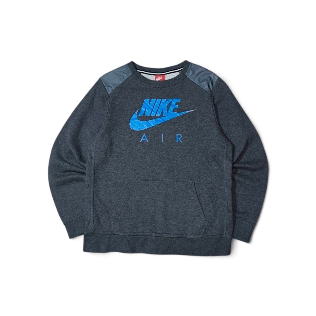Nike Air Grey Blue Sweatshirt Jumper (Category: Coats, Jackets and Outerwear) located in Taguig. Submitted by lloydyy_thrift (Listing ID 1471006879, Image 1). Description: - Color: Dark grey marled with bright blue Nike Air chest graphic - Details: Contrast nylon shoulder patches for a stylish, utilitarian look - Fit: Classic crewneck with ribbed cuffs and hem - Material: Warm, soft, and comfortable fabric - Condition: Excellent pre-loved/new (re