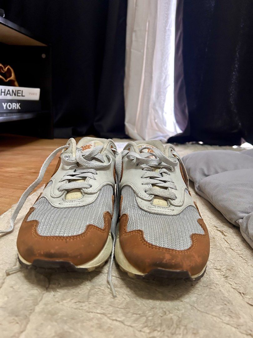 Nike Air Max 1 Patta Monarch Size 7.5 (Category: Sneakers) located in Mandaluyong City. Submitted by kyliekaye (Listing ID 1470934418, Image 2). Description: - Model: Nike Air Max 1 x Patta 'Monarch' - Size: US 7.5 - Colorway: Metallic Silver / White / Burnt Orange - Details: Signature wavy mudguard, Patta tongue branding, and custom insoles - Condition: Worn a few times, minor scuffs on the orange mudguard, and normal toe box creasing - Soles: S