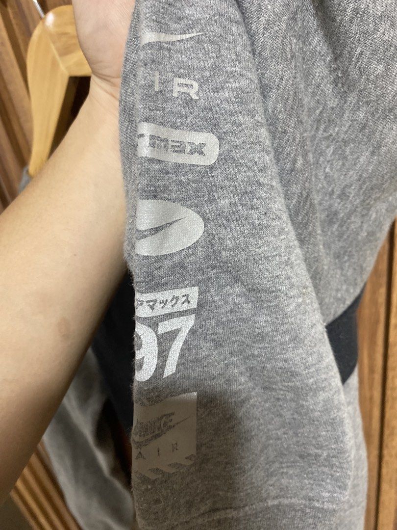 Nike Air Max 97 Grey Black Sweatshirt Size L (Category: Coats, Jackets and Outerwear) located in Caloocan City. Submitted by heatedcaps4425 (Listing ID 1471098641, Image 2). Description: - Brand: Nike - Color: Grey and black with red accents - Size: L (Standard fit) - Design: Red Air logo on chest, stacked Air Max 97 graphics and Japanese katakana text on sleeve - Details: Ribbed crewneck, cuffs, and hem - Interior: Soft and cozy fleece - Conditi