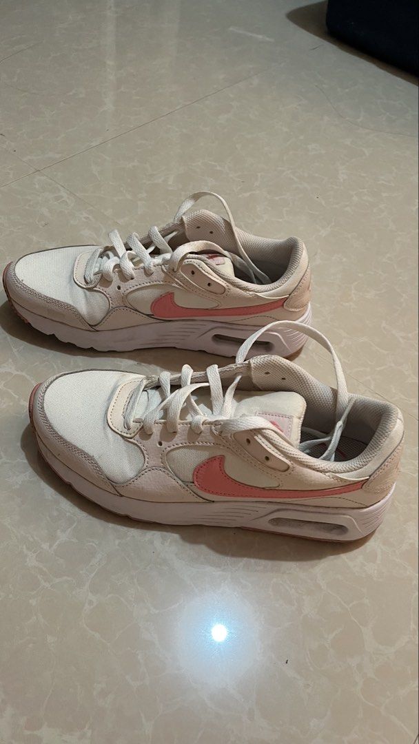 Nike Air Pink White Sneakers (Category: Sneakers) located in Bay. Submitted by ronellie (Listing ID 1471096660, Image 2). Description: - Brand/Model: Nike Air low-top sneakers Size9 - Colorway: Classic white with pink accents - Details: Pink swoosh branding and pink heel embroidery - Materials: Canvas and leather upper with white laces - Condition: Solid structure with minor dirt on soles from previous wear - Style: Great everyday shoes for walki