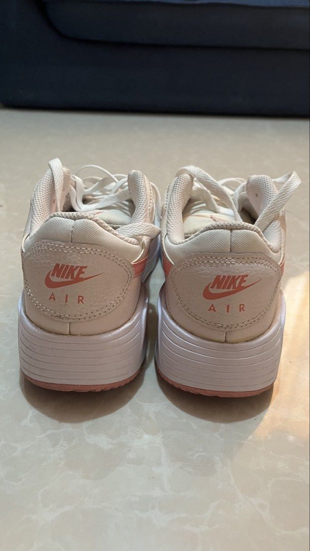 Nike Air Pink White Sneakers (Category: Sneakers) located in Bay. Submitted by ronellie (Listing ID 1471096660, Image 3). Description: - Brand/Model: Nike Air low-top sneakers Size9 - Colorway: Classic white with pink accents - Details: Pink swoosh branding and pink heel embroidery - Materials: Canvas and leather upper with white laces - Condition: Solid structure with minor dirt on soles from previous wear - Style: Great everyday shoes for walki