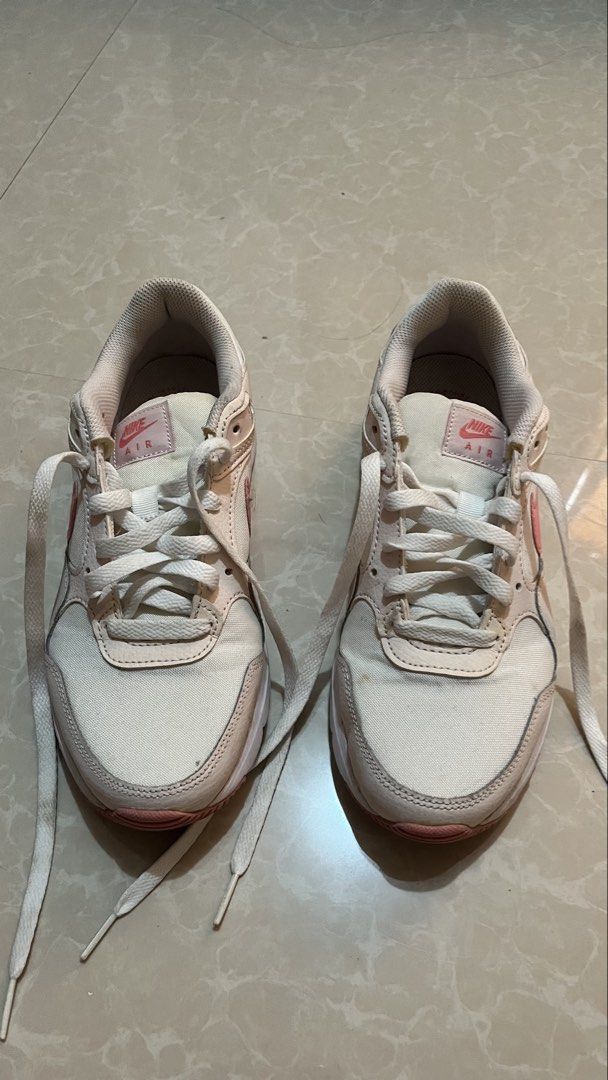 Nike Air Pink White Sneakers (Category: Sneakers) located in Bay. Submitted by ronellie (Listing ID 1471096660, Image 1). Description: - Brand/Model: Nike Air low-top sneakers Size9 - Colorway: Classic white with pink accents - Details: Pink swoosh branding and pink heel embroidery - Materials: Canvas and leather upper with white laces - Condition: Solid structure with minor dirt on soles from previous wear - Style: Great everyday shoes for walki