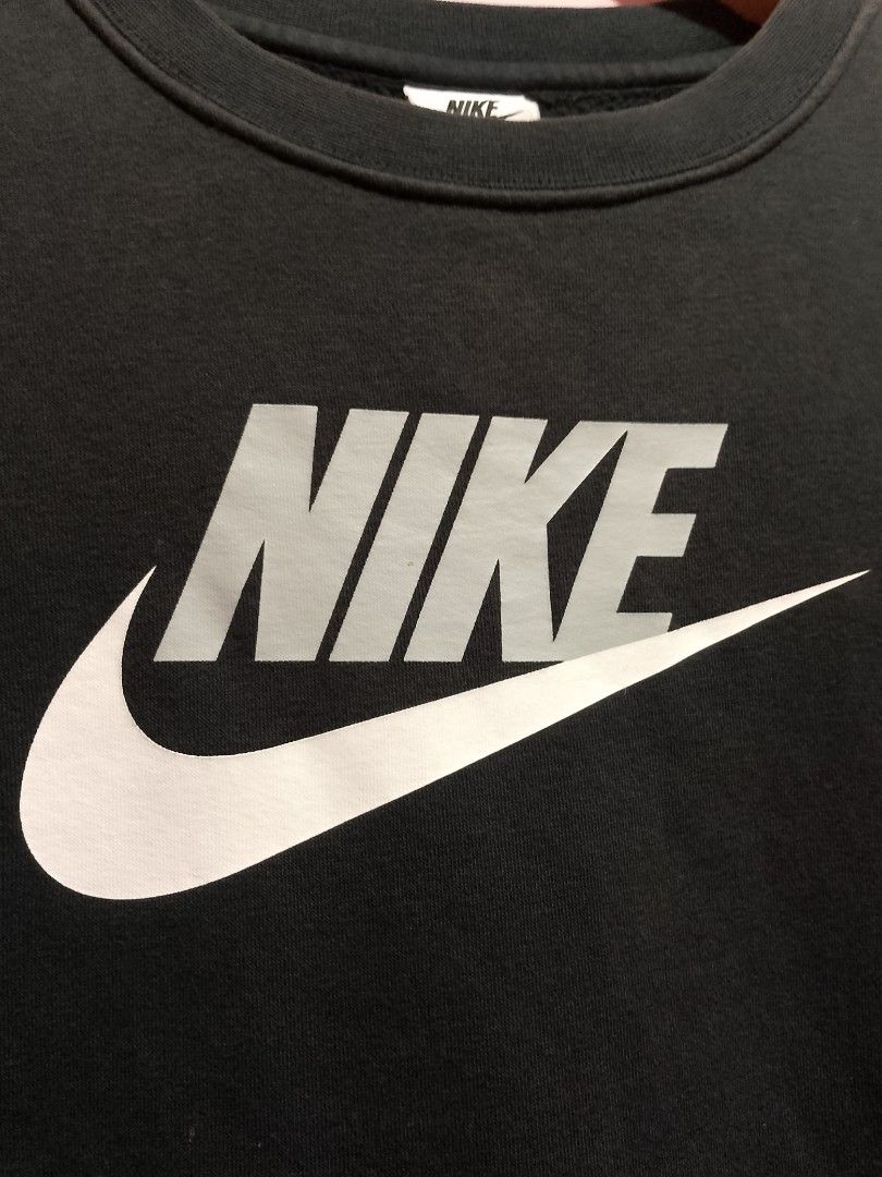Nike Black Graphic Sweatshirt Size L (Category: Coats, Jackets and Outerwear) located in General Trias. Submitted by elmerafelix-42143 (Listing ID 1470945924, Image 2). Description: - Brand: Nike - Style: Crewneck sweatshirt - Color: Black with large grey and white chest logo - Size: L (Tag on collar) - Dimensions 19.5x23 - Material: 80% Cotton, 20% Polyester - Style Code: CV9297-011 - Features: Ribbed cuffs and hem for a snug fit - Origin: Made 