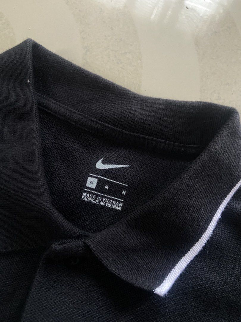 Nike Black Polo Shirt Size M (Category: Tshirts & Polo Shirts ) located in Manila. Submitted by noblehorse_f6bbe8 (Listing ID 1471063217, Image 2). Description: - Brand: Nike - Color: Black with white tipping on collar and cuffs - Size: Medium (M), Classic Fit - Material: 100% Cotton, Made in Vietnam - Logo: White embroidered Nike swoosh on right chest - Condition: Clean, great shape, ready to wear - Perfect for: Casual outings or sports.