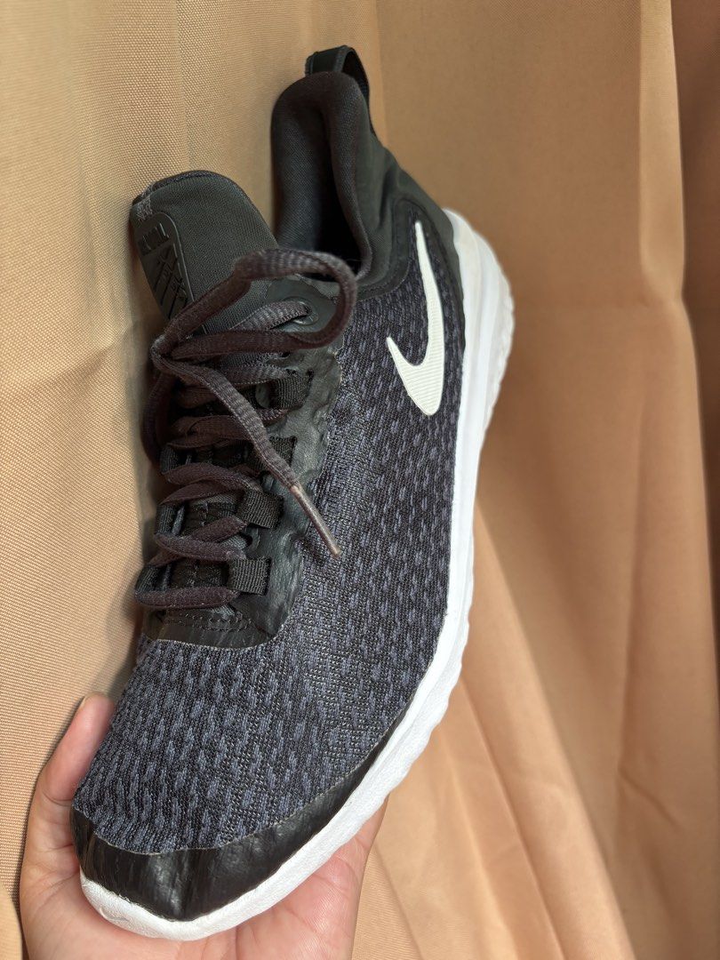 Nike Black White Running Shoes (Category: Sneakers) located in Bacacay. Submitted by true.carmiebalq (Listing ID 1471116388, Image 1). Description: - Brand: Nike - Color: Black and dark grey with white swoosh - Upper: Breathable fabric mesh to keep feet cool - Sole: Cushioned white sole with great grip - Closure: Traditional black lace-up for a secure fit - Features: Convenient pull tab at the back for easy wear - Ideal for: Gym workouts, running