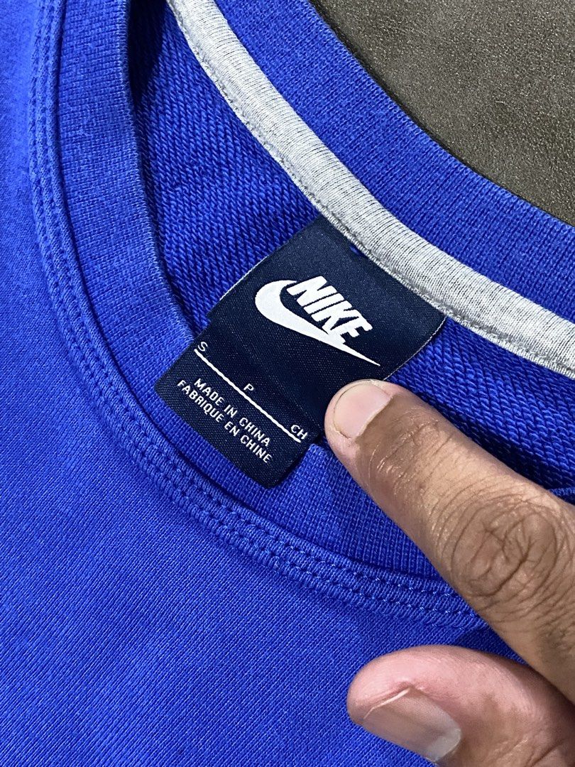 Nike Blue Sweatshirt Size S (Category: Coats, Jackets and Outerwear) located in Rizal. Submitted by dripprojectph (Listing ID 1470955502, Image 3). Description: - Brand: Nike - Color: Blue with red embroidered swoosh - Size: S - Material: 100% cotton - Origin: Made in China - Details: Ribbed cuffs, collar, and hem with clean interior lining and white neck tape - Condition: Excellent, great for everyday casual wear.