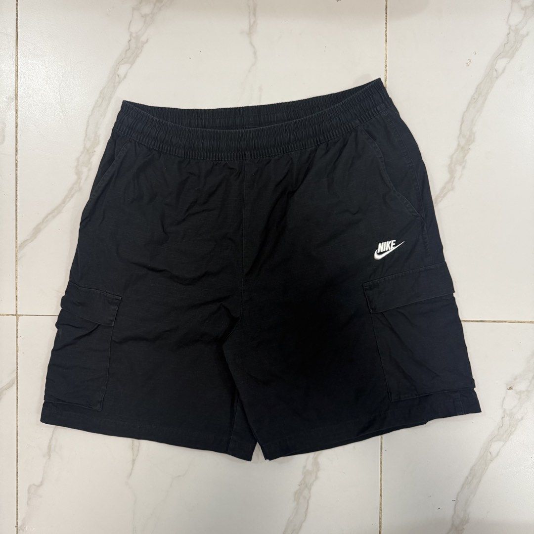 Nike Cargo Shorts Black Size 2XL (Category: Shorts) located in Caloocan City. Submitted by ayogorenia1002 (Listing ID 1471030808, Image 2). Description: - Brand/Model: Nike Cargo Shorts - Size: XXL - Color: Black - Material: Cotton with ripstop texture - Waistband: Elastic with internal drawstring - Pockets: Utility cargo pockets on both sides - Details: Small white embroidered Nike logo near the left pocket - Condition: Clean overall.