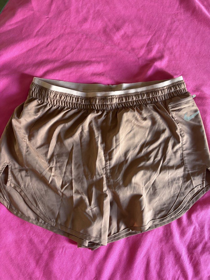 Nike Dri-FIT Running Shorts (Category: Activewear) located in Cainta. Submitted by PreLovedbyANM (Listing ID 1471001518, Image 1). Description: - Brand: Nike - Style: Dri-FIT running shorts - Color: Terracotta / Clay - Size: Medium (M) - Waistband: Elastic with adjustable 'Nike Running' drawstring - Logo: Reflective silver Swoosh on the front - Storage: Convenient zippered pocket on the right hip - Two inner small pockets at back & front - Suppor