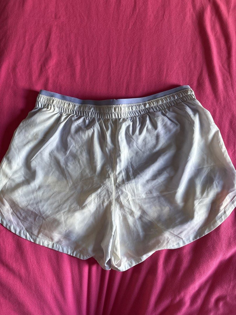 Nike Dri-FIT Running Shorts (Category: Activewear) located in Cainta. Submitted by PreLovedbyANM (Listing ID 1471009492, Image 2). Description: - Authentic Nike running shorts in purple and white - Size: Medium (tag inside) - Dri-FIT moisture-wicking fabric keeps you dry and comfortable - Built-in brief lining for extra support -Mesh pockets at front - Elastic waistband with adjustable Nike Running drawstring - Iconic Swoosh logo on the lower hem