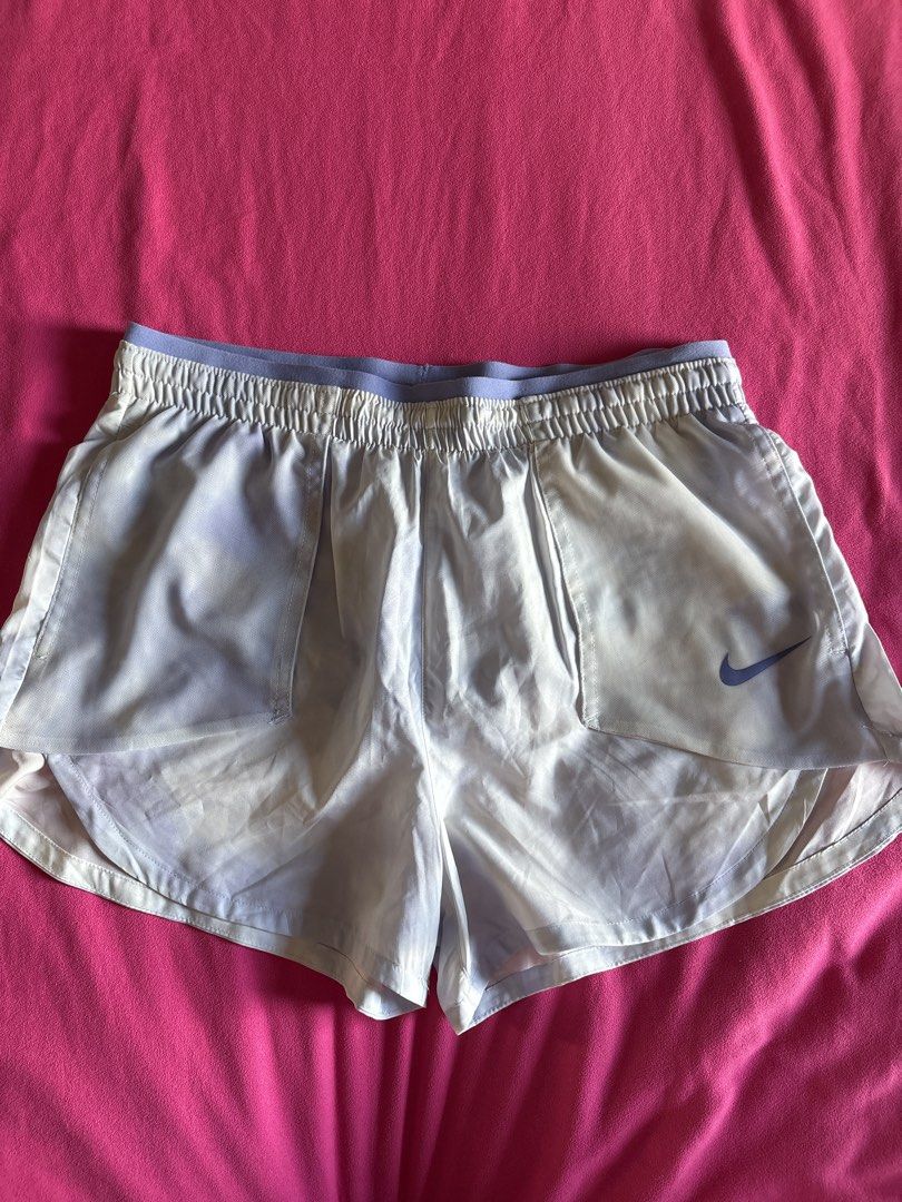 Nike Dri-FIT Running Shorts (Category: Activewear) located in Cainta. Submitted by PreLovedbyANM (Listing ID 1471009492, Image 1). Description: - Authentic Nike running shorts in purple and white - Size: Medium (tag inside) - Dri-FIT moisture-wicking fabric keeps you dry and comfortable - Built-in brief lining for extra support -Mesh pockets at front - Elastic waistband with adjustable Nike Running drawstring - Iconic Swoosh logo on the lower hem