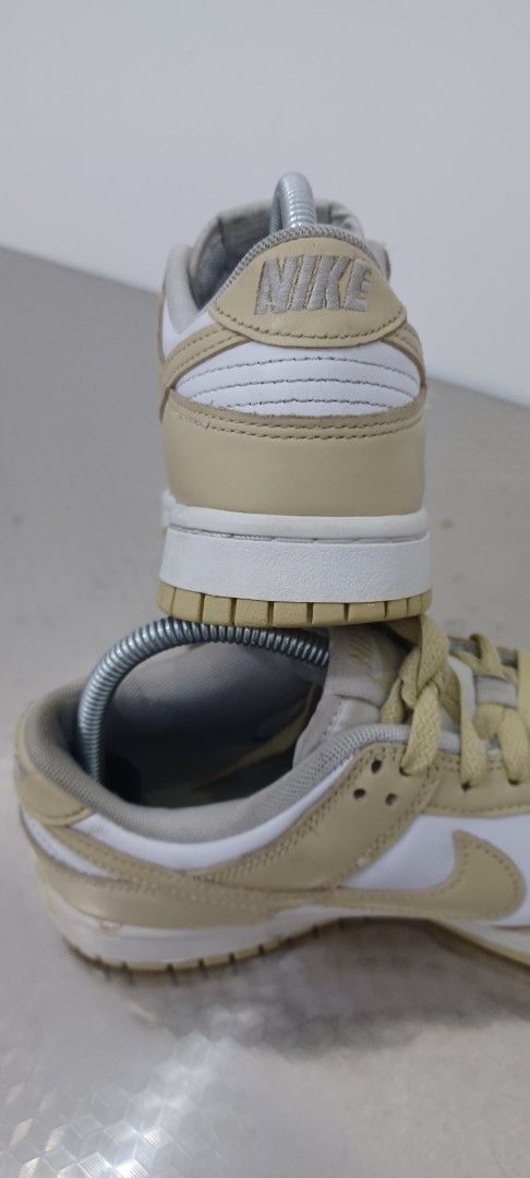 Nike Dunk Low Cream Beige White Sneakers (Category: Sneakers) located in Polangui. Submitted by Kariton (Listing ID 1471113167, Image 3). Description: - Brand: Nike - Model: Dunk Low - Colorway: Cream Beige and White - Material: Leather upper, rubber outsole - Features: Perforated toe box, padded collar, standard lacing - Condition: Light creasing on toe boxes, minor scuff marks on midsole, no original box - Style: Classic low-top design, easy to