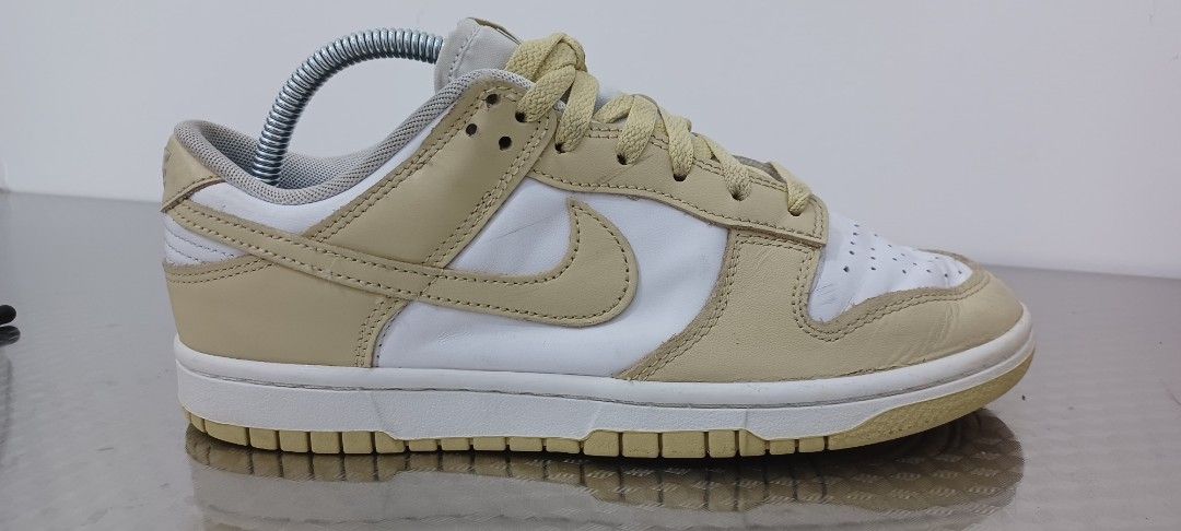 Nike Dunk Low Cream Beige White Sneakers (Category: Sneakers) located in Polangui. Submitted by Kariton (Listing ID 1471113167, Image 1). Description: - Brand: Nike - Model: Dunk Low - Colorway: Cream Beige and White - Material: Leather upper, rubber outsole - Features: Perforated toe box, padded collar, standard lacing - Condition: Light creasing on toe boxes, minor scuff marks on midsole, no original box - Style: Classic low-top design, easy to