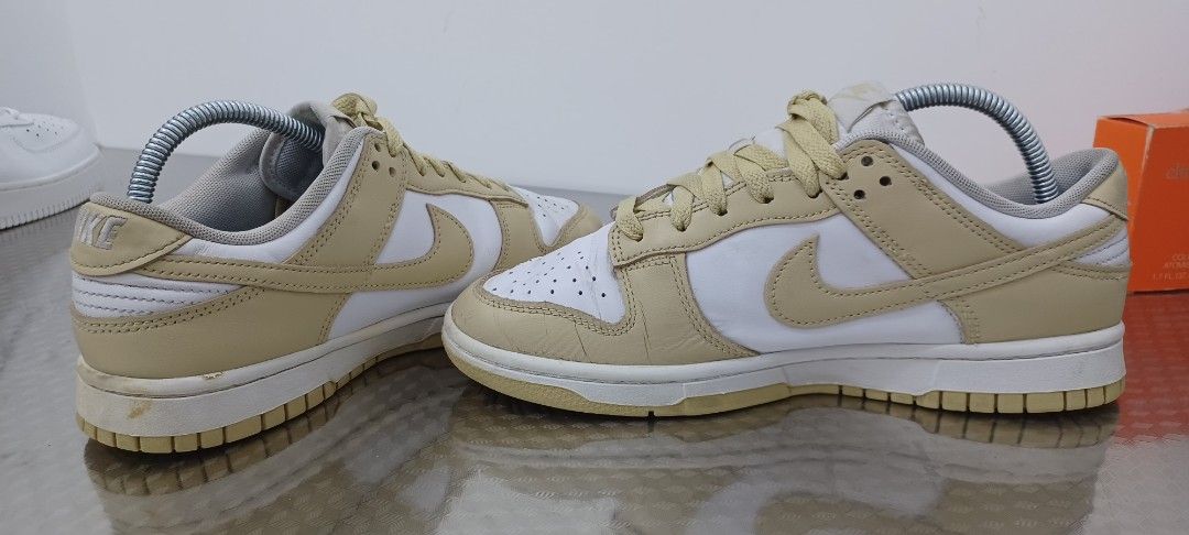 Nike Dunk Low Cream Beige White Sneakers (Category: Sneakers) located in Polangui. Submitted by Kariton (Listing ID 1471113167, Image 2). Description: - Brand: Nike - Model: Dunk Low - Colorway: Cream Beige and White - Material: Leather upper, rubber outsole - Features: Perforated toe box, padded collar, standard lacing - Condition: Light creasing on toe boxes, minor scuff marks on midsole, no original box - Style: Classic low-top design, easy to