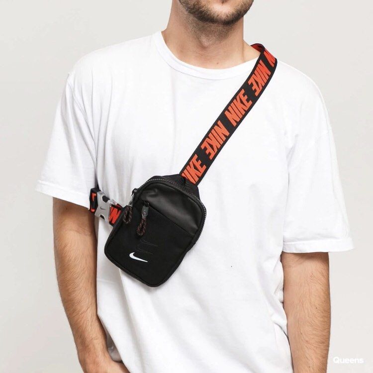 Nike Essentials Cross body bag (Category: Sling Bags) located in Manila. Submitted by jiiiiiiiiiims (Listing ID 1471046344, Image 3). Description: - Authentic Nike crossbody bag in versatile black - Eye-catching orange strap lettering and classic white Nike swoosh logo - Durable nylon and polyester construction built to last - Multiple zippered compartments to keep your daily essentials organized - Adjustable buckle strap for a secure and customi
