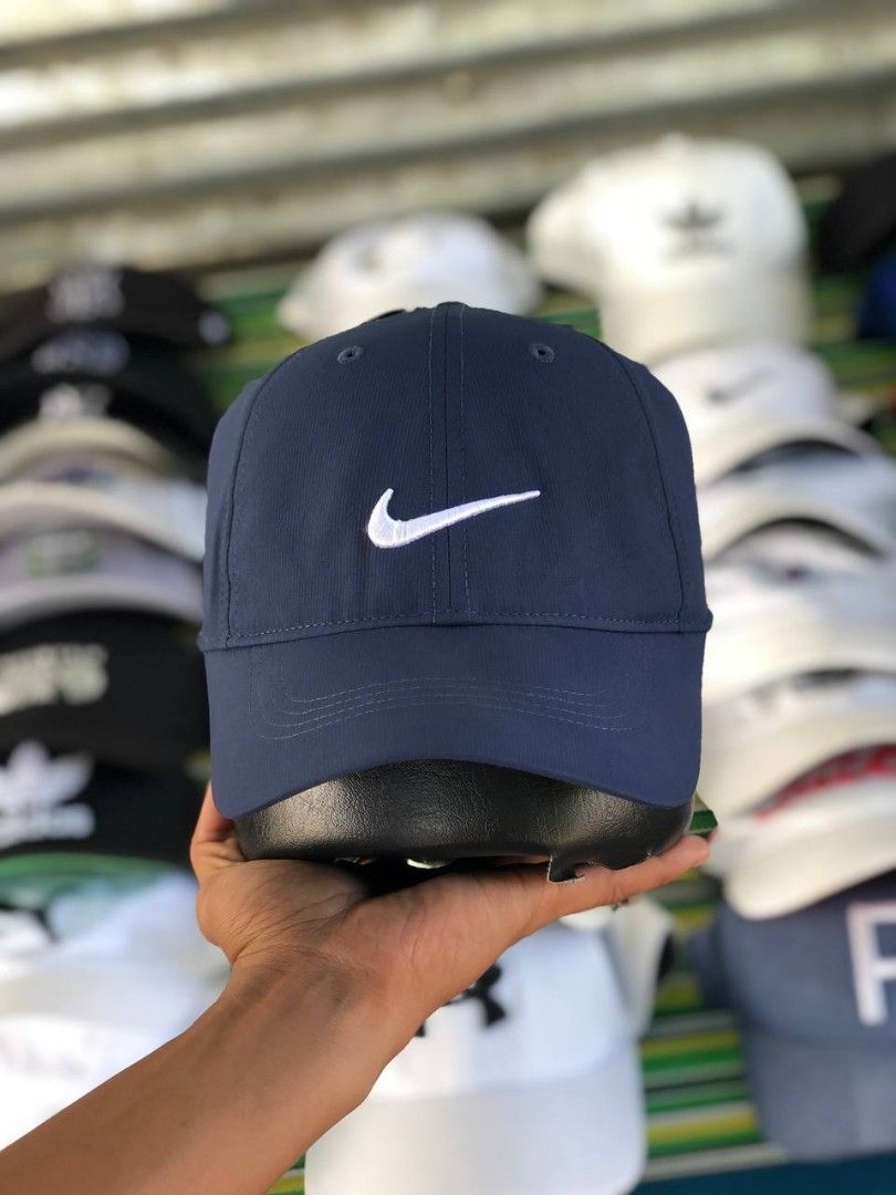 Nike Golf Navy Blue Baseball Cap (Category: Caps & Hats) located in Manila. Submitted by jowiegarci63146 (Listing ID 1470958226, Image 1). Description: - Color: Dark blue with white embroidered Nike swoosh - Material: 100% lightweight and breathable polyester - Fit: One size fits most with an adjustable back strap - Detail: Features a cute mini embroidered swoosh on the strap - Authentic Nike Golf gear (nikebetterworld.com tag).