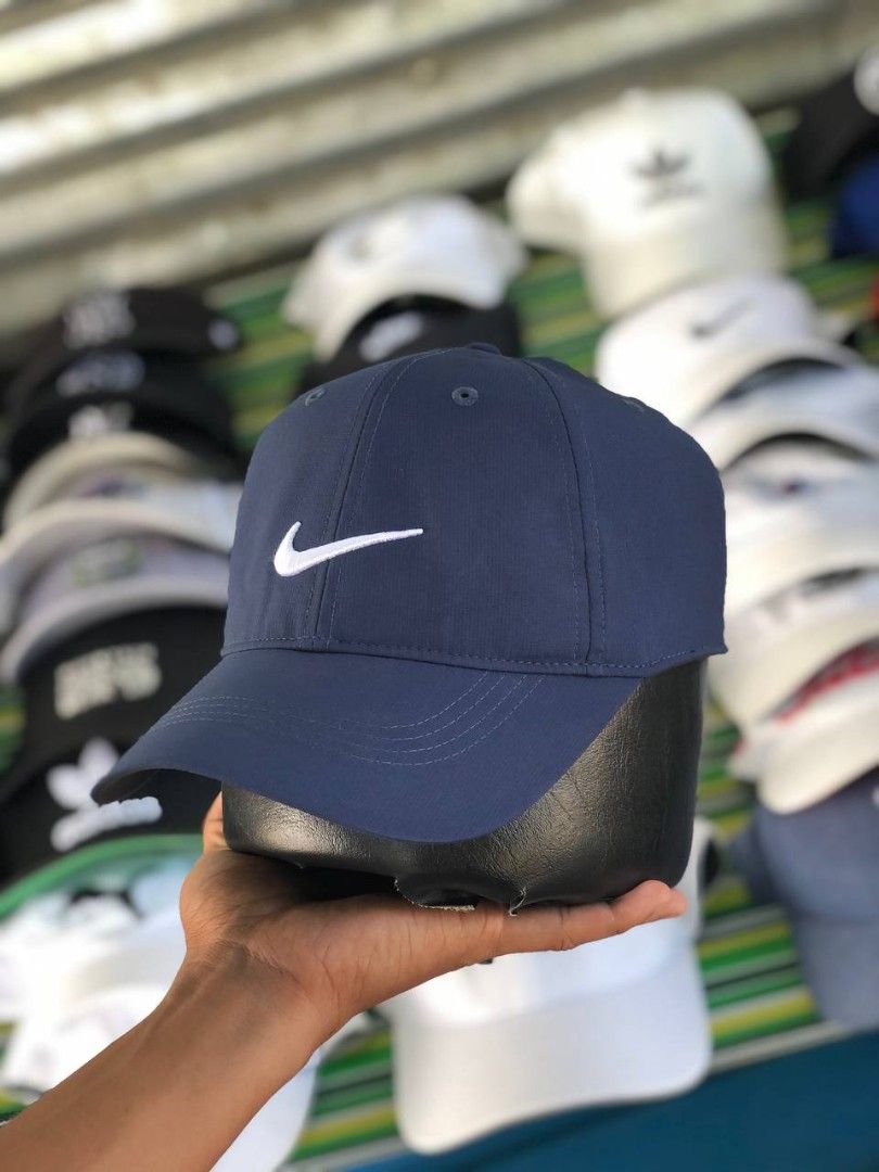 Nike Golf Navy Blue Baseball Cap (Category: Caps & Hats) located in Manila. Submitted by jowiegarci63146 (Listing ID 1470958226, Image 2). Description: - Color: Dark blue with white embroidered Nike swoosh - Material: 100% lightweight and breathable polyester - Fit: One size fits most with an adjustable back strap - Detail: Features a cute mini embroidered swoosh on the strap - Authentic Nike Golf gear (nikebetterworld.com tag).