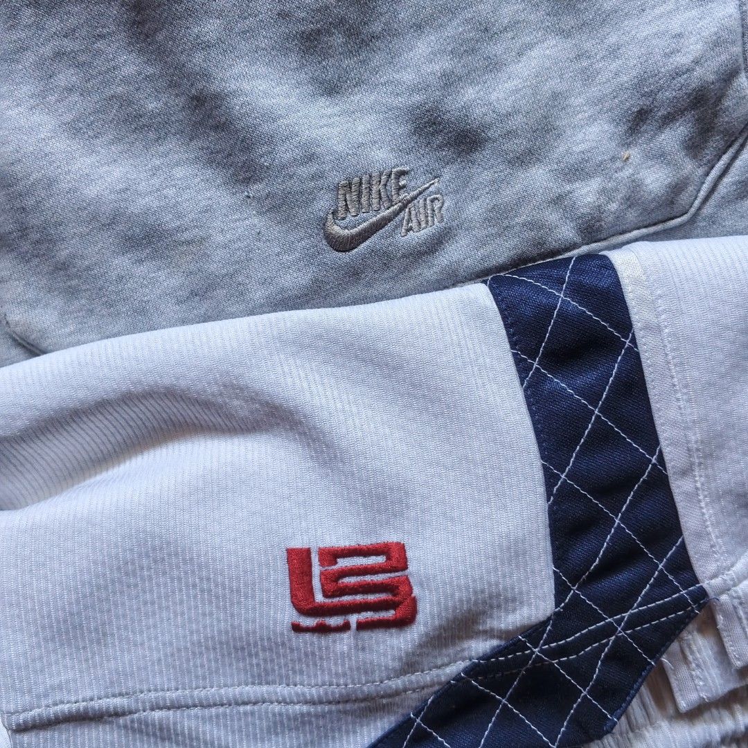 Nike LeBron and Nike Air Shorts Bundle (Category: Shorts) located in Paranaque City. Submitted by thriftine5 (Listing ID 1470991957, Image 2). Description: - Size: XL - Material: Cotton & polyester blend - Pair 1: White mesh LeBron James shorts with navy blue stripe and functional pockets - Pair 2: Grey fleece Nike Air shorts with cargo pockets and elastic drawstring waist - Features: Both pairs have functional pockets and adjustable waistbands -