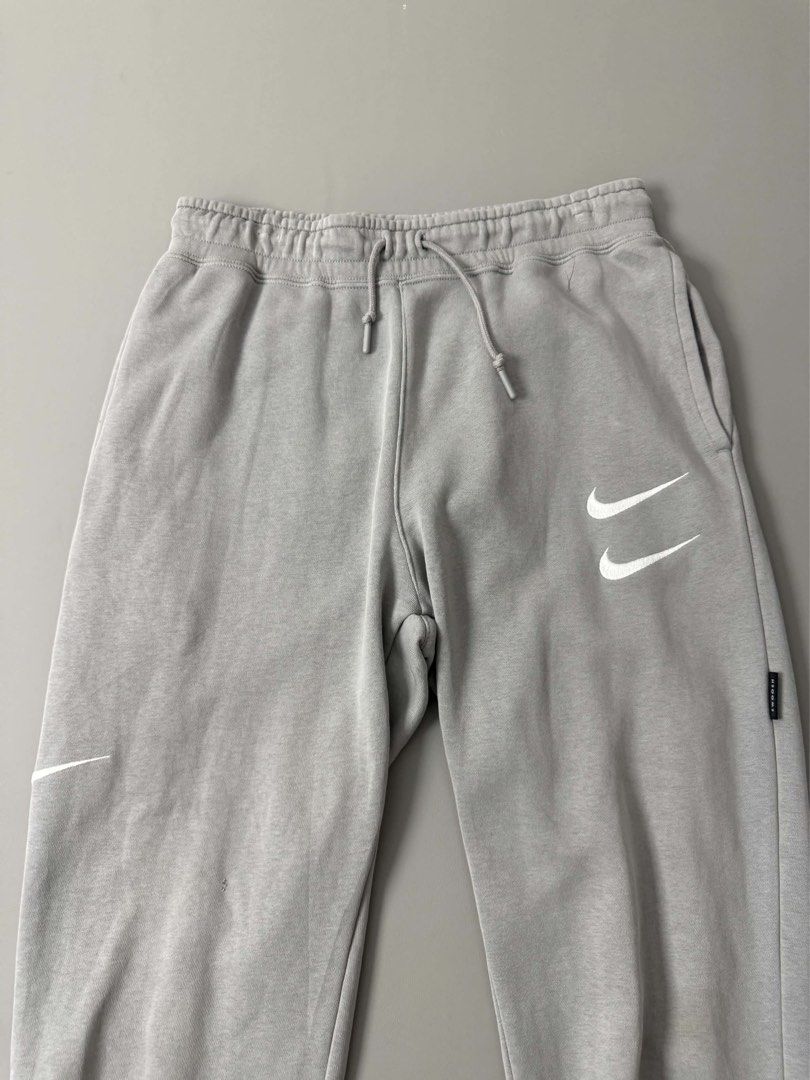 NIKE NSW SWOOSH PANTS (Category: Joggers) located in Guagua. Submitted by sweetboyy (Listing ID 1471067496, Image 2). Description: NIKE NSW SWOOSH PANTS GOOD CONDITION / ISSUE: PIN HOLE & STAIN SIZE MEDIUM ON TAG DIMES: WAISTLINE 30-34 / LENGTH 36.