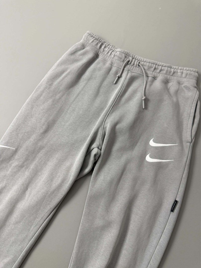 NIKE NSW SWOOSH PANTS (Category: Joggers) located in Guagua. Submitted by sweetboyy (Listing ID 1471067496, Image 3). Description: NIKE NSW SWOOSH PANTS GOOD CONDITION / ISSUE: PIN HOLE & STAIN SIZE MEDIUM ON TAG DIMES: WAISTLINE 30-34 / LENGTH 36.