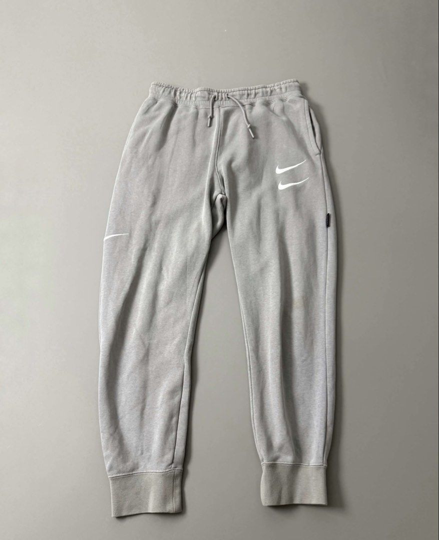 NIKE NSW SWOOSH PANTS (Category: Joggers) located in Guagua. Submitted by sweetboyy (Listing ID 1471067496, Image 1). Description: NIKE NSW SWOOSH PANTS GOOD CONDITION / ISSUE: PIN HOLE & STAIN SIZE MEDIUM ON TAG DIMES: WAISTLINE 30-34 / LENGTH 36.
