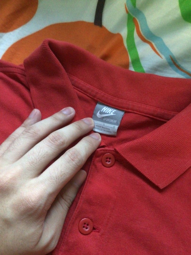 Nike Polo Shirt (Category: Tshirts & Polo Shirts ) located in General Trias. Submitted by dunht (Listing ID 1471082253, Image 2). Description: - Brand: Nike Sportswear - Item: Red Polo Shirt - Size: L - Material: 100% Cotton - Details: White Nike logo on chest, 'SECURITY' text with number 72 and keys graphic on the back - Condition/Extras: Includes extra button on inner care tag - Origin: Made in China.