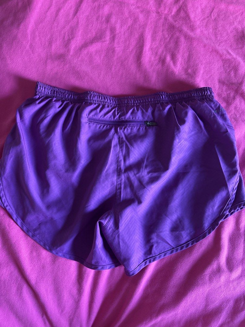 Nike Purple Dri-FIT Running Shorts (Category: Activewear) located in Cainta. Submitted by PreLovedbyANM (Listing ID 1471006299, Image 3). Description: - Brand: Nike - Color: Purple - Technology: Dri-FIT moisture-wicking fabric - Fit: Elastic waistband with internal drawstring - Storage: Convenient back zipped pocket for essentials. One small inner pocket at the back - Comfort: Built-in brief liner - Ideal for: Running, workouts, and gym sessions 