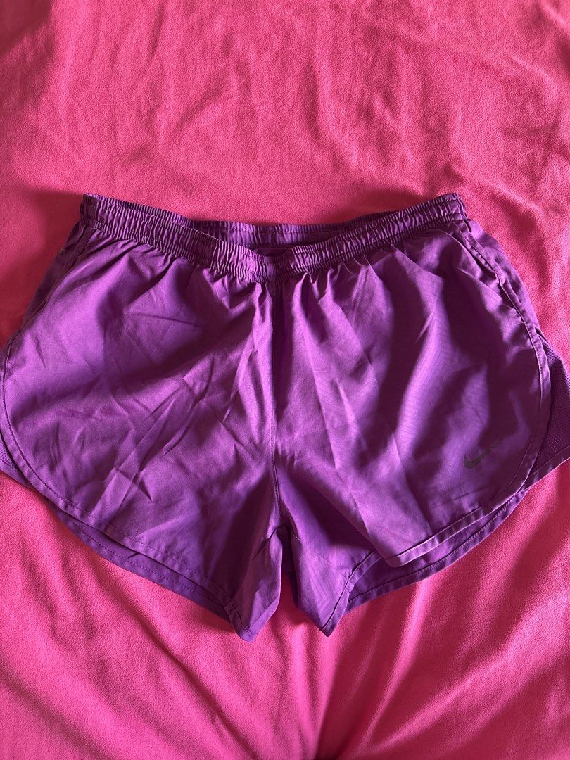 Nike Purple Dri-FIT Running Shorts (Category: Activewear) located in Cainta. Submitted by PreLovedbyANM (Listing ID 1471006299, Image 1). Description: - Brand: Nike - Color: Purple - Technology: Dri-FIT moisture-wicking fabric - Fit: Elastic waistband with internal drawstring - Storage: Convenient back zipped pocket for essentials. One small inner pocket at the back - Comfort: Built-in brief liner - Ideal for: Running, workouts, and gym sessions 