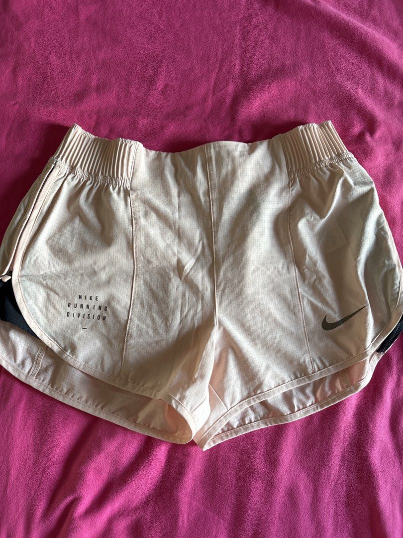 Nike Running Division Shorts (Category: Activewear) located in Cainta. Submitted by PreLovedbyANM (Listing ID 1471003276, Image 1). Description: - Brand: Nike Running Division - Color: Light Pink and Black - Size: Medium - Condition: Like - Branding: Nike Swoosh and Running Division text logo details - Origin: Made in China Washed, never used RFS - no longer fits No COD No other checkout No free shipping/ delivery No meet ups **No return, no exch