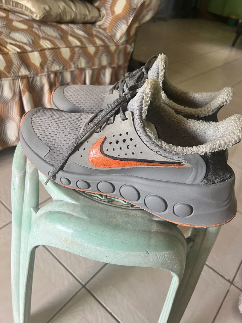 Nike Sneakers for Men (Category: Sneakers) located in Quezon City. Submitted by trisha_1998 (Listing ID 1470962070, Image 2). Description: - Color: Gray with vibrant orange swoosh detailing - Comfort: Warm fleece inner lining for colder days - Sole: Thick gray midsole with circular indentations and classic waffle traction - Closure: Lace-up design with matching gray laces - Features: Dark gray heel panel with a convenient pull tab - Condition: So