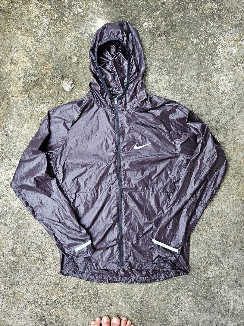 Nike ultra lightweight Windbreaker Jacket (Category: Coats, Jackets and Outerwear) located in Las Pinas. Submitted by rcp123 (Listing ID 1470993397, Image 1). Description: - Brand: Nike - Item: Hooded Windbreaker Jacket - Color: Dark greyish purple - Size: M (Best for chest 95cm, height 165-175cm) - Material: Lightweight polyester, easy to pack for workouts or runs - Features: Full zip front with smooth YKK zipper pull, attached hood - Condition: