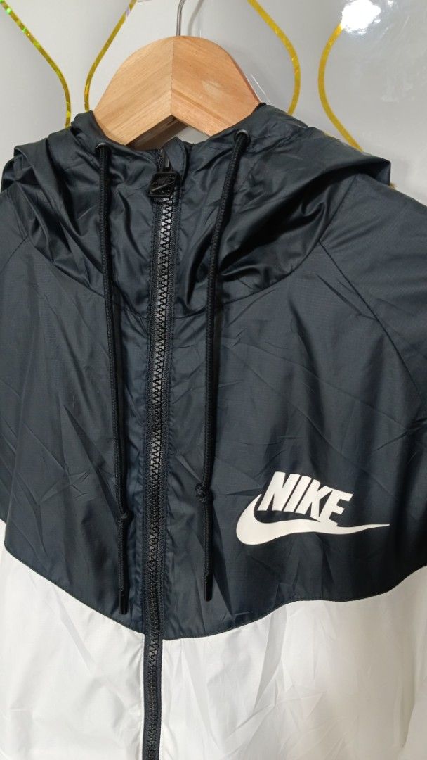 Nike Windrunner Hooded Jacket Black White (Category: Coats, Jackets and Outerwear) located in Manila. Submitted by zariyah.1986 (Listing ID 1470982673, Image 3). Description: - Authentic Nike Windrunner jacket in a timeless black and white colorway - Size: L (Made in Vietnam) - Measurements: 23" width x 26" length - Full zip front with an attached hood for extra coverage - Two secure zipped side pockets - Breathable mesh inner lining - Lightweigh