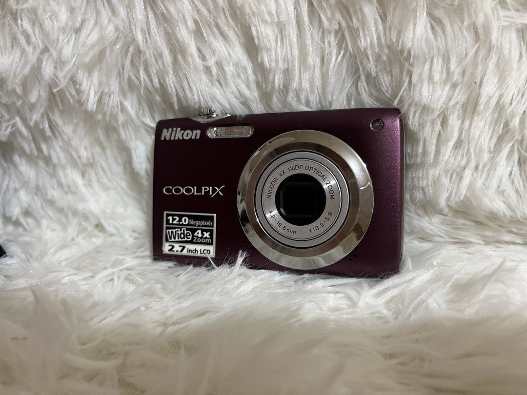 Nikon Coolpix Purple Digital Camera (Category: Cameras) located in Consolacion. Submitted by chiniiii (Listing ID 1471020155, Image 3). Description: - Model: Nikon Coolpix Compact Digital Camera - Color: Vibrant Purple - Resolution: 12.0 Megapixels with 4x Wide Optical Zoom - Display: 2.7-inch LCD screen - Condition: Tested, turns on and menus load properly - Storage: Uses standard SD memory cards - Features: Lightweight, pocket-sized body with s