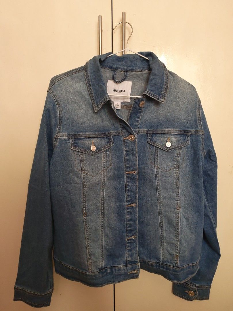 Nine West Denim Jacket Size M (Category: Coats, Jackets and Outerwear) located in Marikina City. Submitted by jennyfromtheblock15 (Listing ID 1470946631, Image 3). Description: - Brand: Nine West - Size: Medium - Color: Classic blue wash - Material: Sturdy cotton blend denim - Features: Button-up front with branded hardware, chest pockets, buttoned cuffs - Fit: Adjustable hem tabs on the back - Condition: Excellent, timeless everyday outerwear.