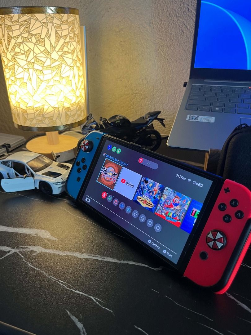 Nintendo Switch OLED Neon Blue and Red Console (Category: Nintendo) located in Caloocan City. Submitted by grandmountain.58b9fc (Listing ID 1471046664, Image 3). Description: Nintendo Switch handheld console with Neon Blue/Red Joy-Cons, custom umbrella thumb grips, black protective case, and screen protector. Fully functional for both portable and docked play. Ready to use! Note: Unit and charger only!!.