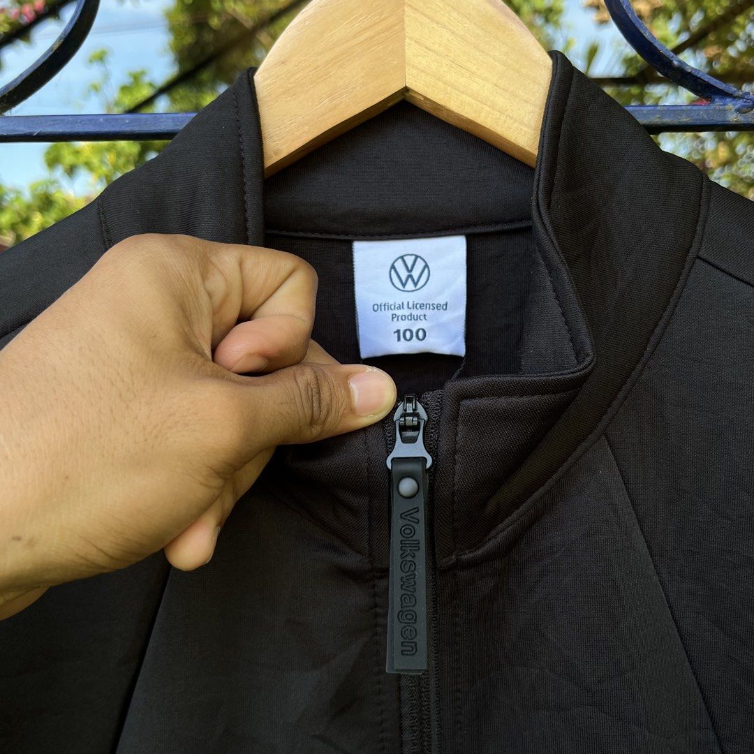 Official Volkswagen Black Zip Jacket Size 100 (Category: Coats, Jackets and Outerwear) located in Davao. Submitted by streetsight (Listing ID 1471020756, Image 2). Description: Official licensed Volkswagen jacket in black. Full zip front with branded pull tab. Small Volkswagen logo on the left chest and sleeve. Contrast dark grey side panels. Size 100 on the collar tag, fits heights 170 to 175cm. Material tag shows 97% polyester and 3% spandex bl